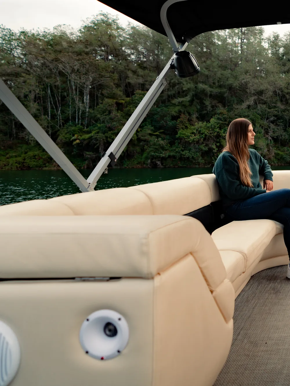 A pontoon with sofas and an awning, moored off the shore of the reservoir.