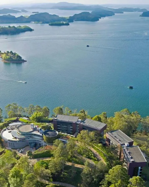 A contemporary hotel on a peninsula of the reservoir, seen from the air.