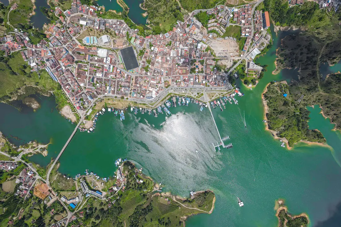 Aerial view of Guatapé: the town surrounded by the arms of the reservoir.