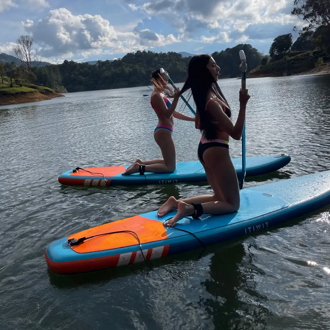 A person standing on a paddleboard on the reservoir.